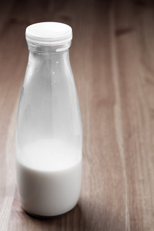 Glass bottle filled with milkの写真素材