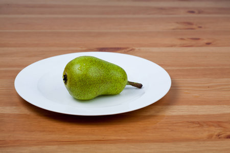 A pear on white plateの写真素材
