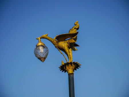 sculpture of golden swarn light pole and bule skyの写真素材