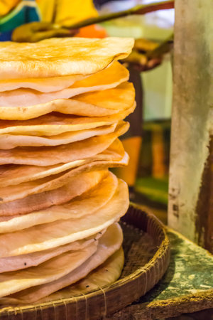 Giant Crispy Rice, The ancient Thai snack combination of rice, sugar syrup, coconut oil, and eggs.
