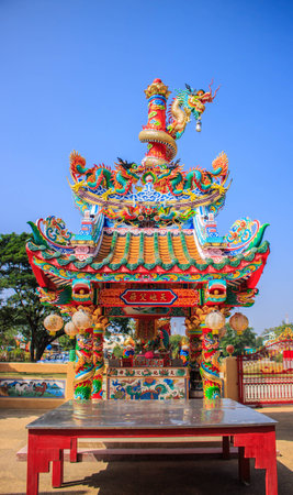 Chinese shrine and dragon pole with blue skyの写真素材