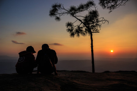 lovely silhouette couple in cliffの写真素材