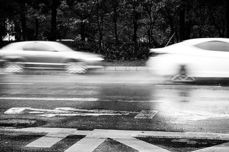 cars speeding in the rainの写真素材