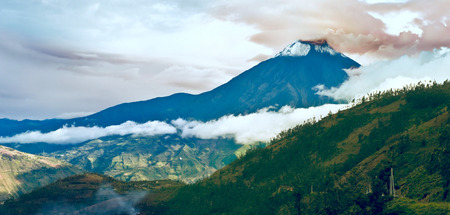 Hermosa Valley with Eruption of a volcano Tungurahua and town Banios de Agua Santa in Ecuadorの写真素材