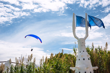 Paraglider over Punta del Este, the Atlantic Coast, Uruguay. Casapueblo, the combination studio, home, museum and hotel designed and built by, and belonging to the artist, Carlos Paez Vilaroの写真素材