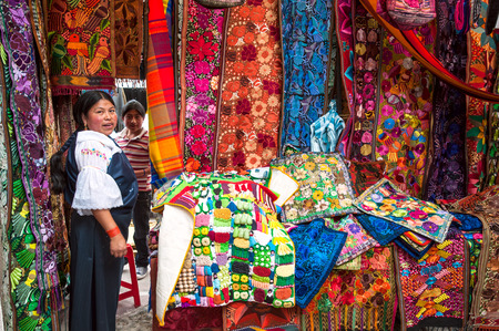 OTAVALO, AUGUST 4, 2012  Indian women in national clothes sells the products of her weaving, as usual on weekdays on the most famous markets in South America, on August 4, 2012 in Otavalo, Ecuadorのeditorial素材