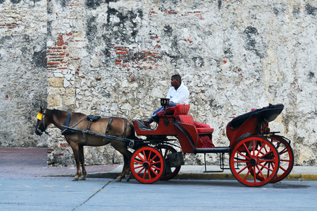 CARTAGENA, MAY 12: Horse drawn touristic carriages waiting alongside the fortified walls of the historic Spanish colonial city of Cartagena de Indias in Colombiaのeditorial素材