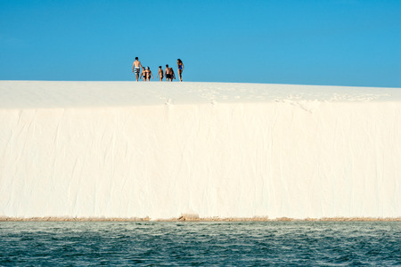 Lencois Maranhenses, Brazil, July 13, 2016 - Tourists are going trouth Sand dunes with blue and green lagoons in Lencois Maranhenses National Parkのeditorial素材