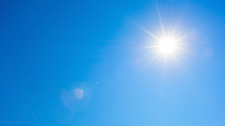 Blue sky with bright sunの写真素材