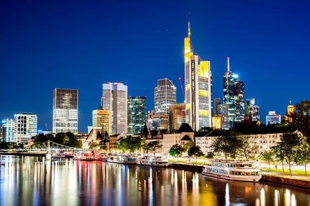 Skyline of Frankfurt with the Main river at nightの写真素材