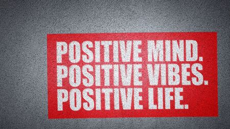 Positive mind, positive vibes, positive life, motivation slogan, white text on gray asphaltの写真素材