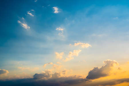 Beautiful soft blue summer sky with clouds at sunset as a background