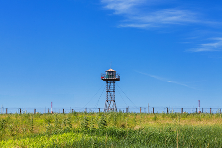 Border burning under the blue sky and white cloudsの写真素材