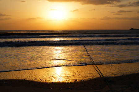 Beautiful sunset on the beach. The sun is setting over the sea.の写真素材