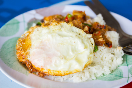 Spicy crispy pork puff with basil and fried egg.の写真素材