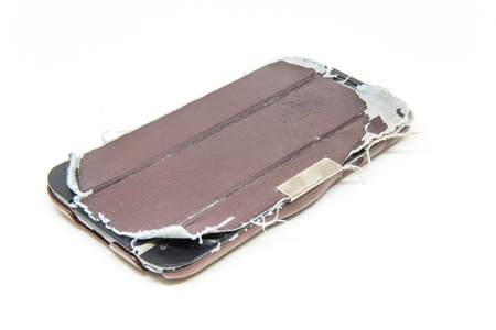 Very old mobile phone case on white background.