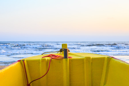 Head of wooden boat with beach, sea and sky.の写真素材