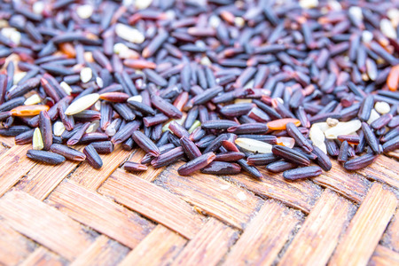 Rice berry on brown handicraft weave wicker.の写真素材