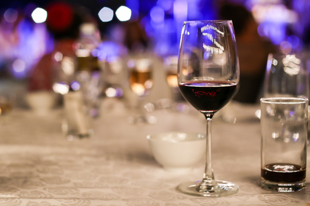 Wine glasses in a restaurant with night bokeh.