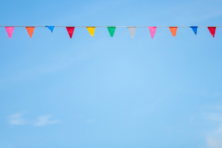 Colorful flag paper with blue sky and cloud background.の写真素材