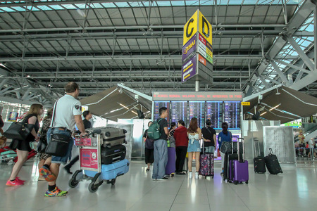 Suvarnabhumi, Bangkok, Thailand. - February 21, 2017 : Passenger watching time schedule table of plane flight at Suvarnabhumi airport.のeditorial素材