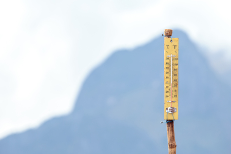 Thermometer on the top of height mountain with 0 or zero degree celsius.