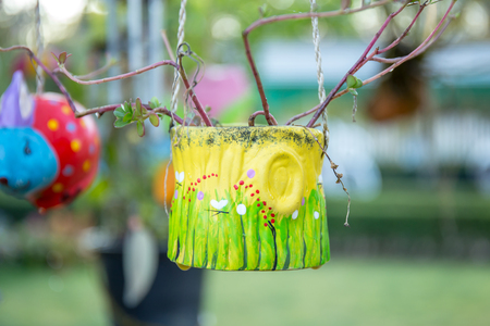 Clay pot hanging in the tree of garden.の写真素材