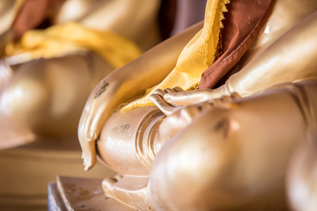 focused on hand of golden buddha statueの写真素材