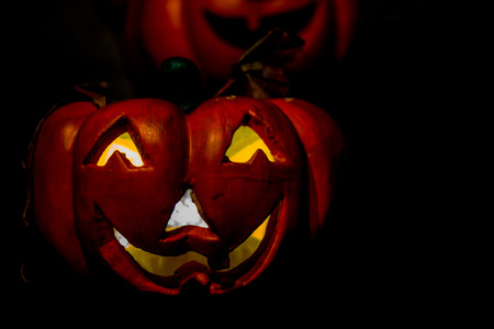 Scary Jack O Lantern Halloween Pumpkin isolated on black or dark background with copy space.の写真素材