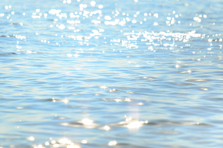 Sun light reflecting or sparkling glitter on water of sea or ocean with beautiful sky blue light tone.の写真素材