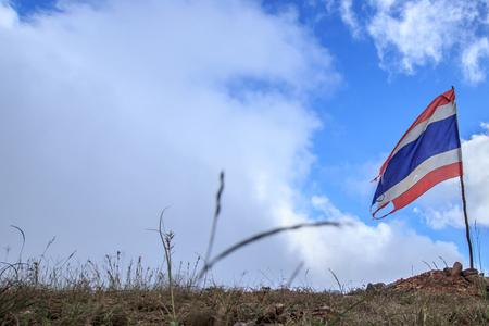 Old or tear of Thailand flag on the hill or mountain.の写真素材