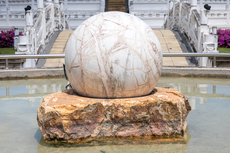 circle marble stone on the concrete stone decoration at water garden.の写真素材