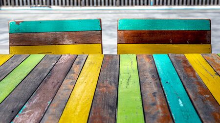 Empty painted wooden table or plank with chair or bench on background for product display.の写真素材