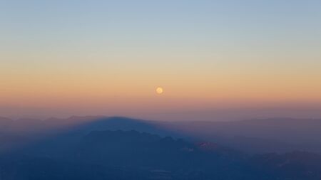 Small moon on the mountain hill of forest.の写真素材