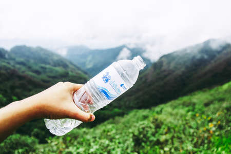 Tak, Thailand. - October 13, 2019 : Plastic bottle of "Singha Water" on the mountain forest with fresh nature concepts. at "LerGuaDa" or "Ler Gwa Dor" Tak province, Thailand, Asia.のeditorial素材