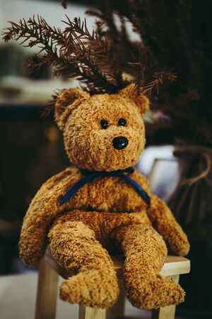 Selective focused on cute teddy bear sit on the chair or bench.の写真素材
