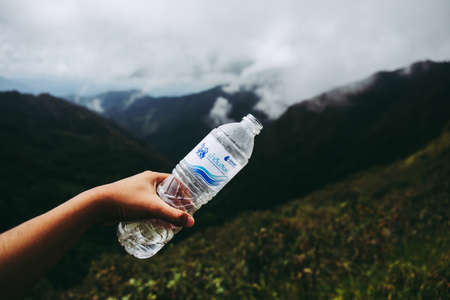 Tak, Thailand. - October 13, 2019 : Plastic bottle of "Singha Water" on the mountain forest with fresh nature concepts. at "LerGuaDa" or "Ler Gwa Dor" Tak province, Thailand, Asia.のeditorial素材