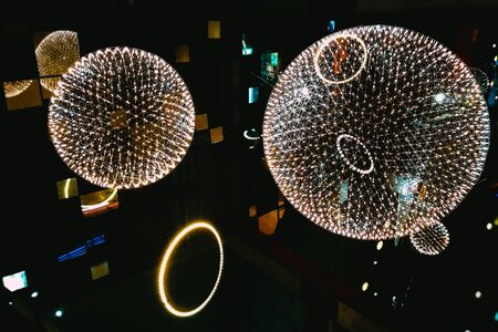Big circle globe light like earth planet star in space or universe hang on the ceiling. in dark or black background.の写真素材