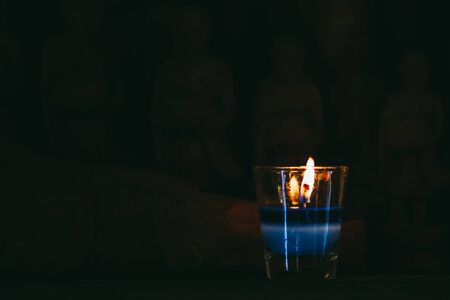 Colorful scented candles with beautiful lighting in dark tone.の写真素材