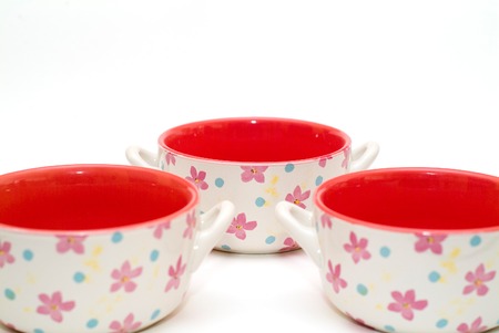 modern colourfull red soup cups with flowers, focus on far cup