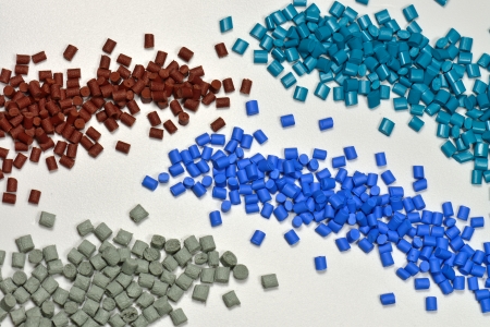 little heap of tinted polymer resin pellets 