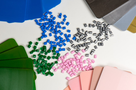 dyed polymer resin granules with color samples on whiteの写真素材