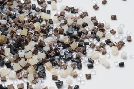 Regrind and virgin polymer resins on whiteの写真素材