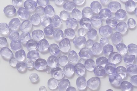 round transparent polymer pellets on white in laboratory
