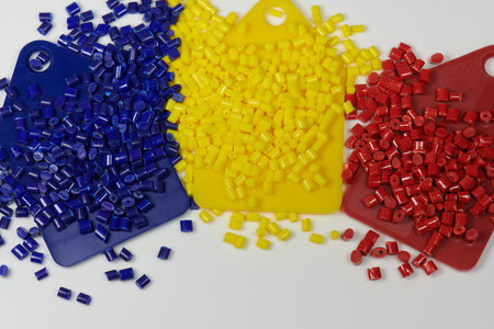 Colored plastic resins in test tubes in laboratory with color samples
