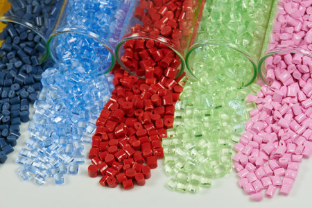 Multicolored plastic beads isolated on white background. close up