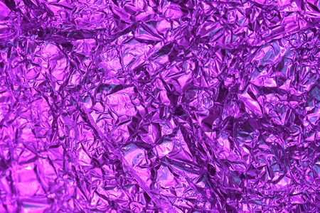 Purple crumpled aluminum foil background textureの写真素材