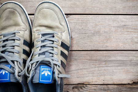 Used classic adidas on old wood floor. This file is cleaned and retouched.のeditorial素材