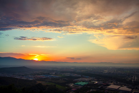 Countryside sunset over the mountains, magical cloudsの写真素材