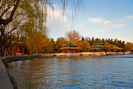 Beijing Beihai Park lakeside Five-Dragon Pavilion and weeping willow scenery.の写真素材